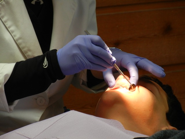 cosmetic dentist checking a patient's teeth